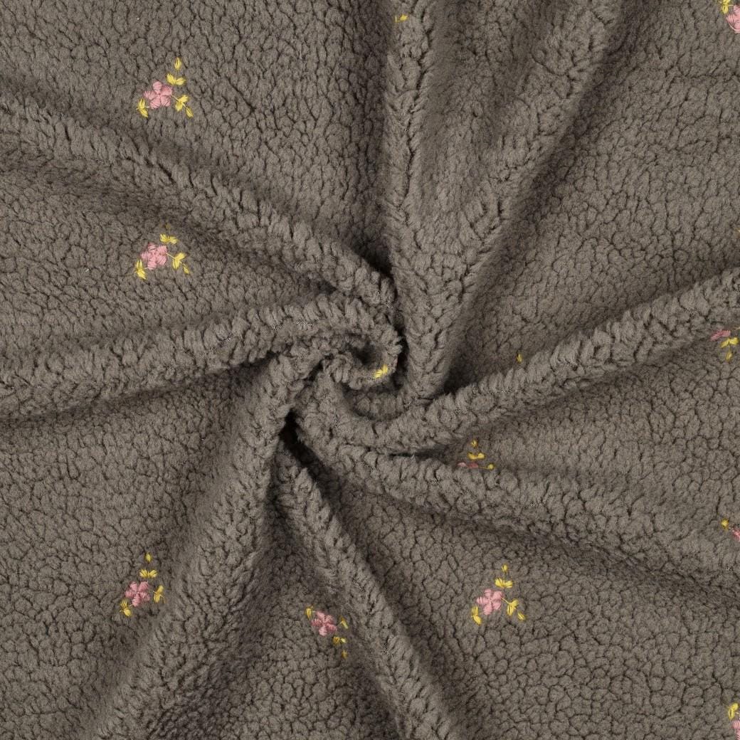 Teddy Stoff mit gestickten Blumen
